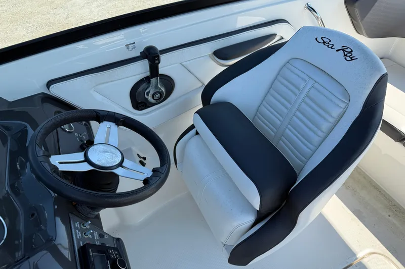 Slide: The Image of 2017 Sea Ray SPX 190 Outboard cockpit with steering wheel and branded seat. - 5