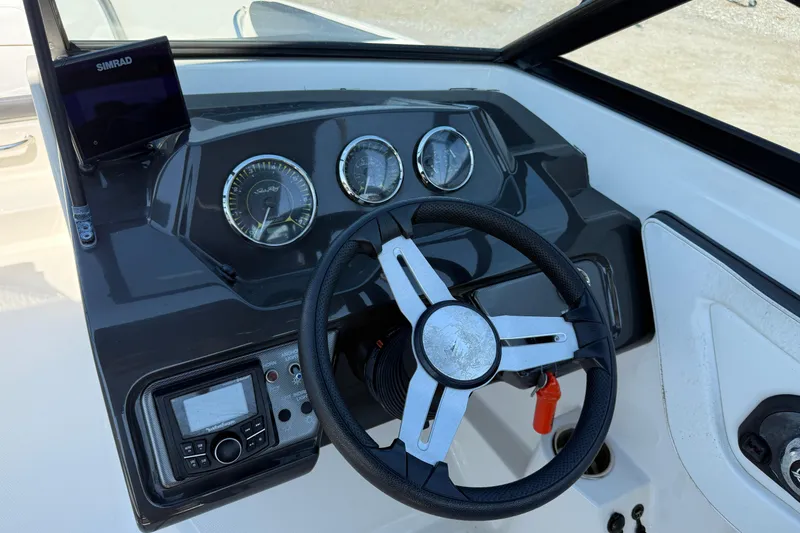 Slide: The Image of 2017 Sea Ray SPX 190 Outboard dashboard with steering wheel and instrument panel. - 6