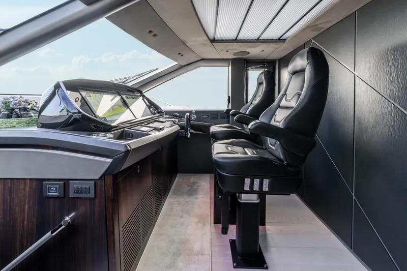 Slide: The Image of Luxurious cockpit of 2023 Sunseeker 90 Ocean yacht with sleek black leather seats. - 18
