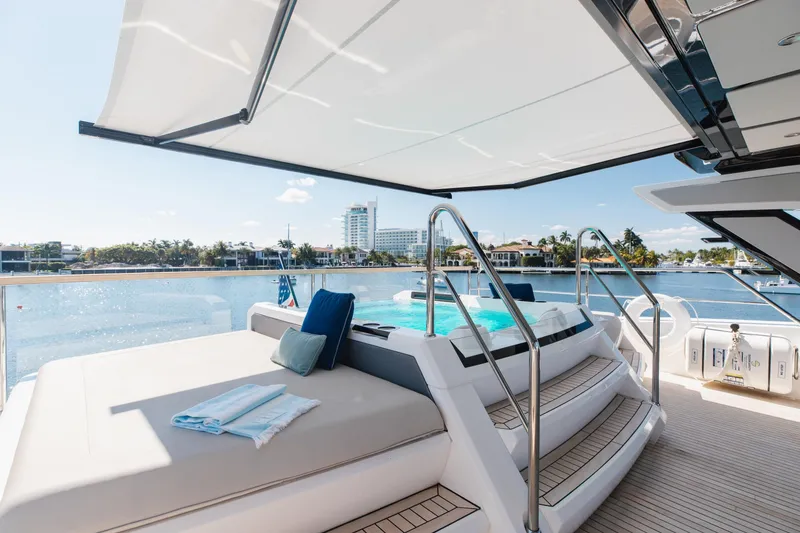 Slide: The Image of Luxurious Sunseeker 90 Ocean yacht deck with pool, 2023 model, overlooking serene waterfront. - 38