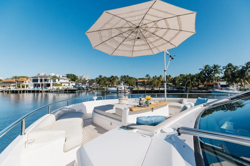 Slide: The Image of Luxurious 2023 Sunseeker 90 Ocean yacht deck with seating, umbrella, and waterfront view. - 41