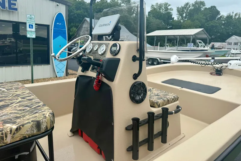 Slide: The Image of 2025 Carolina Skiff E18 JVX CC boat interior with Garmin navigation system and camo seating. - 13
