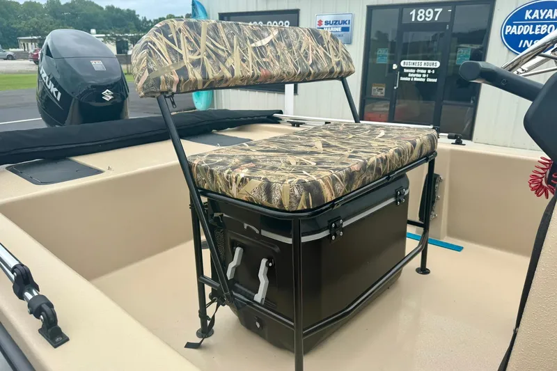 Slide: The Image of 2025 Carolina Skiff E18 JVX CC boat with camo seating and Suzuki outboard motor. - 15
