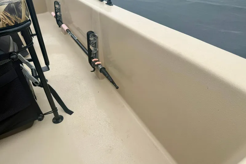 Slide: The Image of 2025 Carolina Skiff E18 JVX CC interior with fishing rod holders and seating. - 17