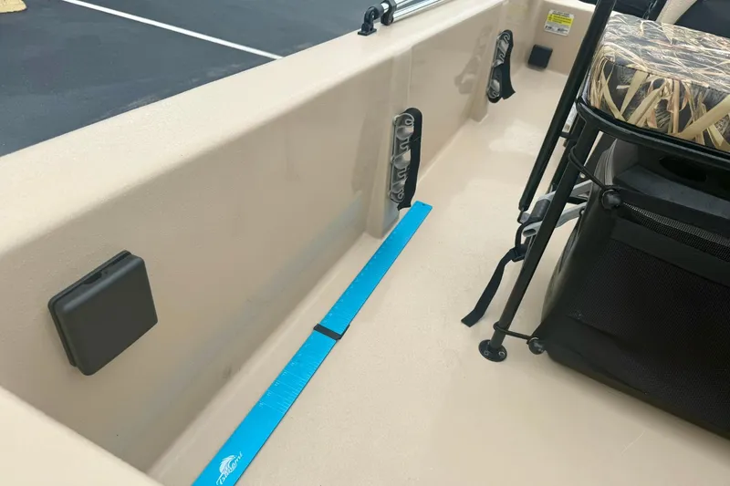 Slide: The Image of 2025 Carolina Skiff E18 JVX CC interior with seating and storage features. - 18