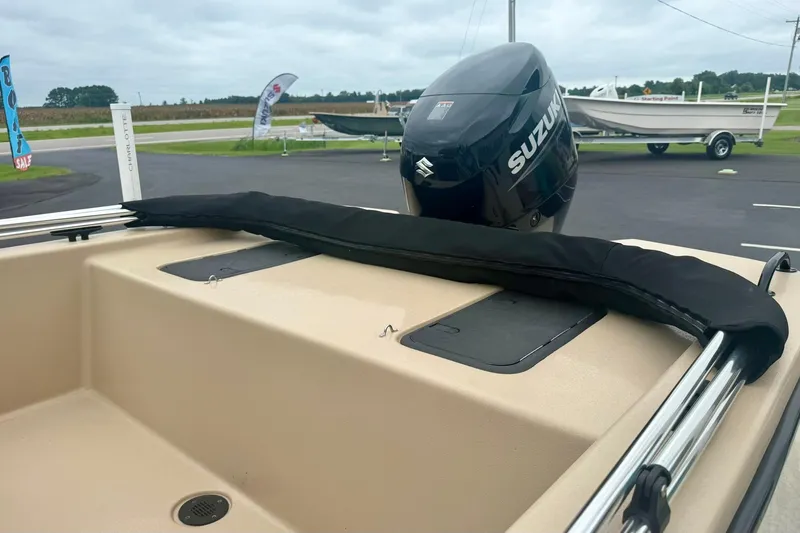 Slide: The Image of 2025 Carolina Skiff E18 JVX CC boat with Suzuki outboard motor in parking lot. - 19