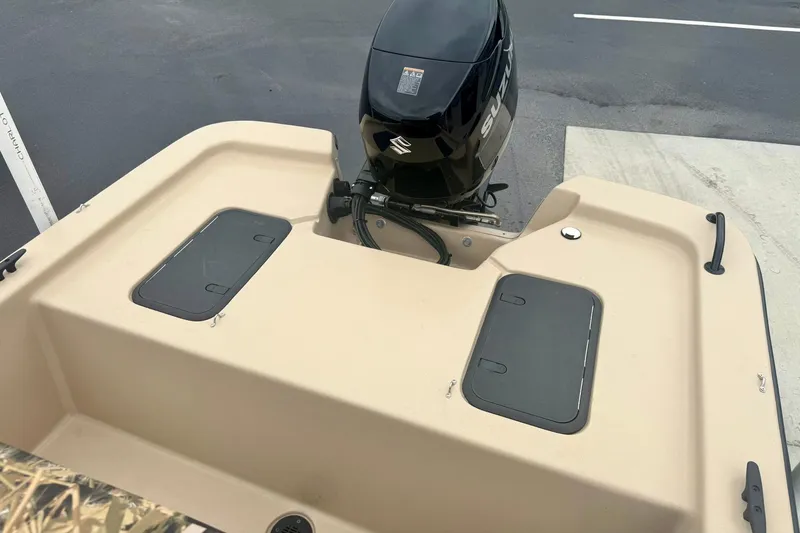 Slide: The Image of 2025 Carolina Skiff E18 JVX CC boat with Suzuki outboard motor, beige deck. - 20