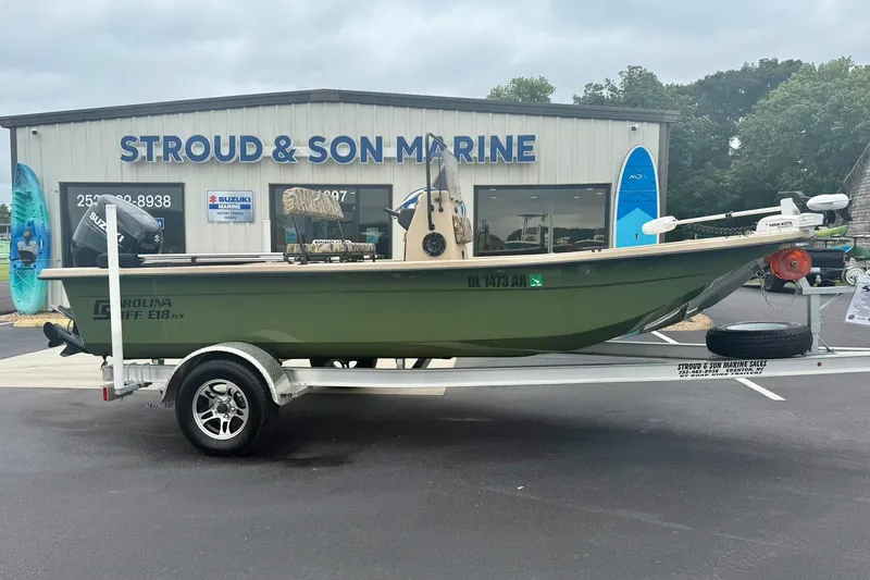 Slide: The Image of 2025 Carolina Skiff E18 JVX CC boat on trailer at Stroud & Son Marine dealership. - 6