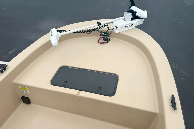 Slide: The Image of 2025 Carolina Skiff E18 JVX CC boat with Minn Kota trolling motor on deck. - 7