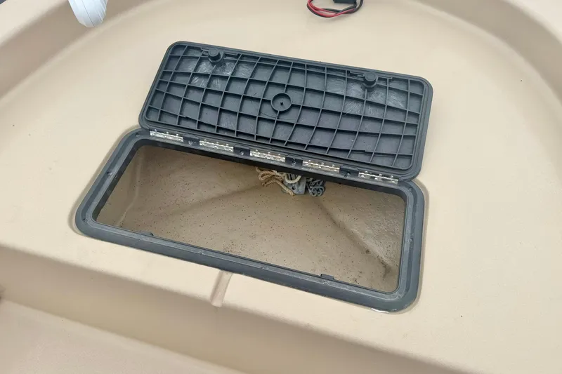 Slide: The Image of Open storage compartment on 2025 Carolina Skiff E18 JVX CC boat. - 8