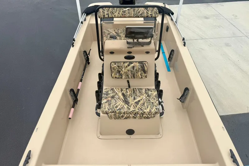 Slide: The Image of 2025 Carolina Skiff E18 JVX CC boat interior with camouflage seating and fishing rod holders. - 9