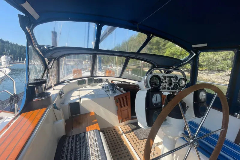 Slide: The Image of Cockpit of 1981 Mariner 48 yacht with steering wheel and navigation instruments. - 10