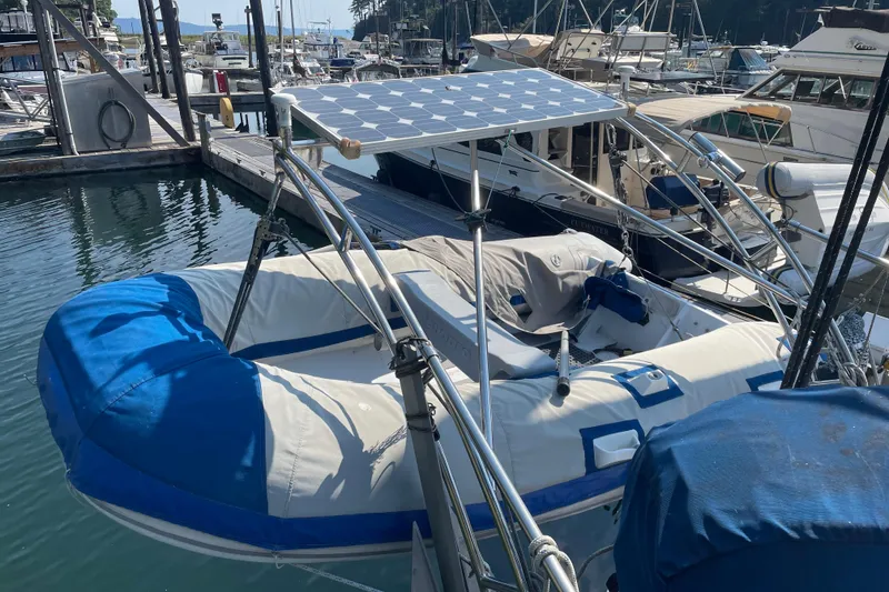 Slide: The Image of Inflatable boat with solar panel docked near Mariner 48 yacht, 1981 model. - 12