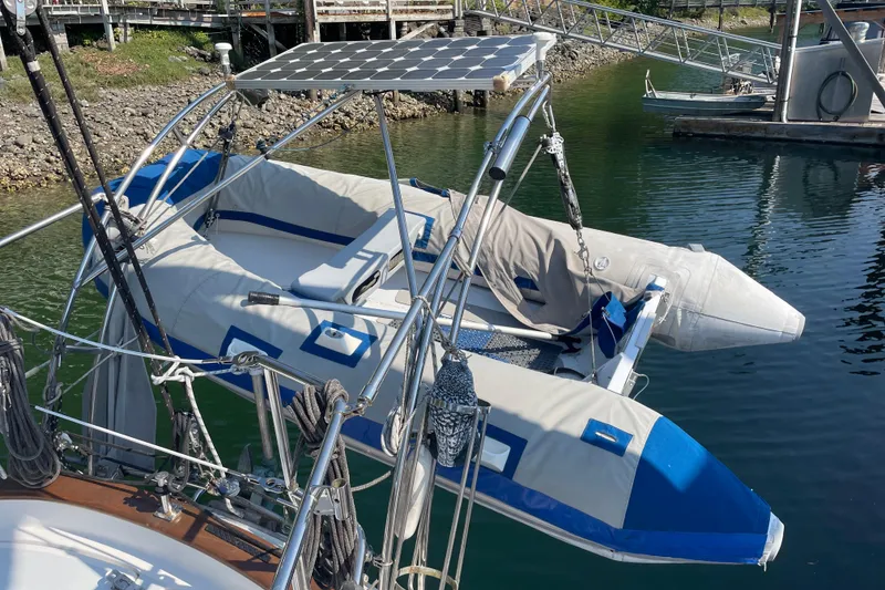 Slide: The Image of Inflatable boat on 1981 Mariner 48 yacht with solar panel, docked in marina. - 13