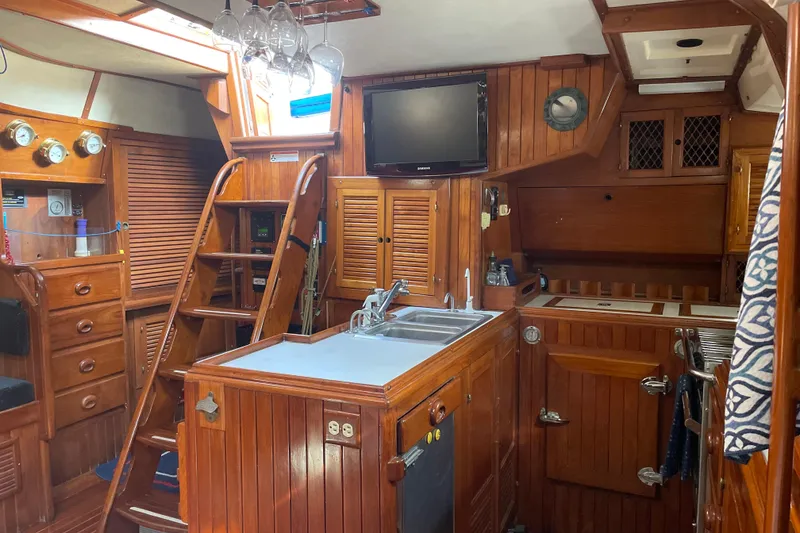 Slide: The Image of Interior of 1981 Mariner 48 yacht with wooden cabinetry and modern amenities. - 18