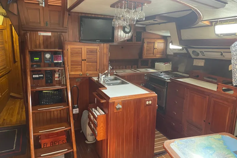 Slide: The Image of Interior of a 1981 Mariner 48 yacht with wooden cabinetry and modern amenities. - 20