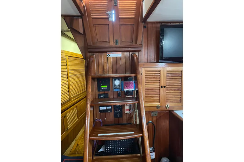 Slide: The Image of 1981 Mariner 48 yacht interior with wooden stairs and control panels. - 21