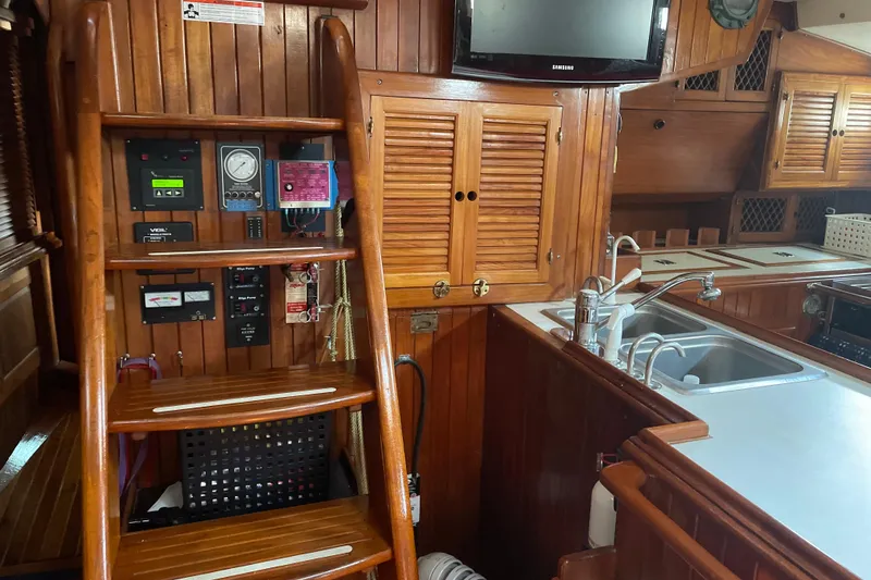 Slide: The Image of Interior of 1981 Mariner 48 yacht with wooden cabinetry and modern kitchen amenities. - 24