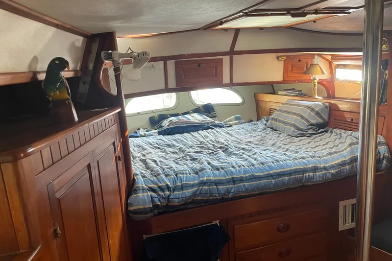 Slide: The Image of Cozy cabin interior of 1981 Mariner 48 yacht with striped bedding and wooden furnishings. - 26