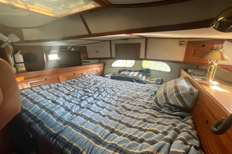 Slide: The Image of Cozy cabin interior of 1981 Mariner 48 yacht with striped bedding and wooden accents. - 28