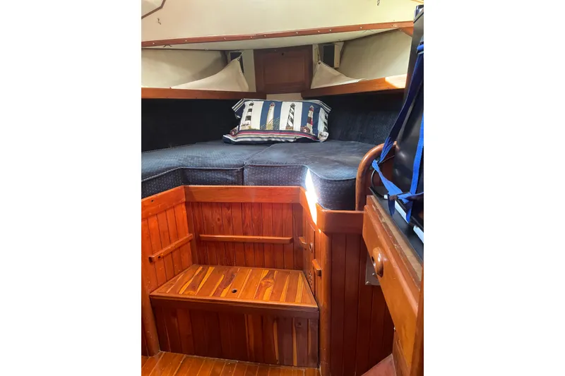 Slide: The Image of 1981 Mariner 48 yacht cabin with wooden interior and cozy bedding. - 31