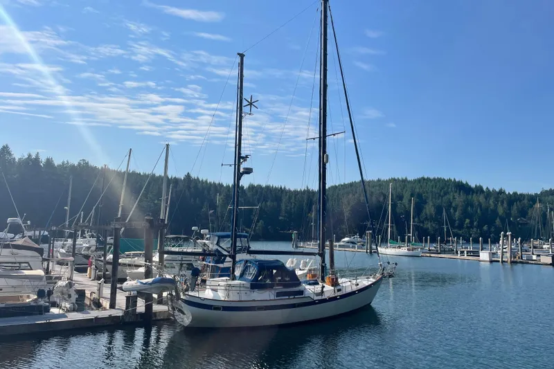 Slide: The Image of Sailboat docked in a marina, Mariner 48 model, 1981, under clear blue sky. - 35