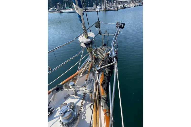 Slide: The Image of 1981 Mariner 48 sailboat deck with rigging, docked in a marina. - 37