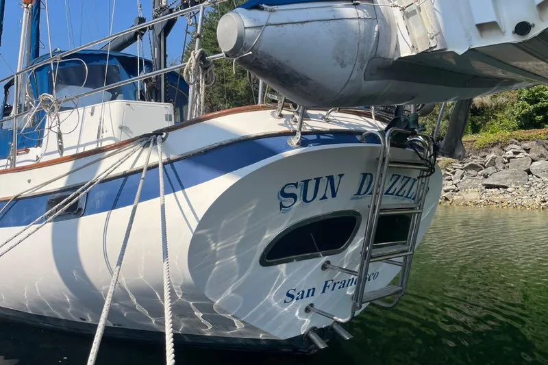 Slide: The Image of 1981 Mariner 48 sailboat "Sun Dazzler" docked, featuring blue and white design. - 40