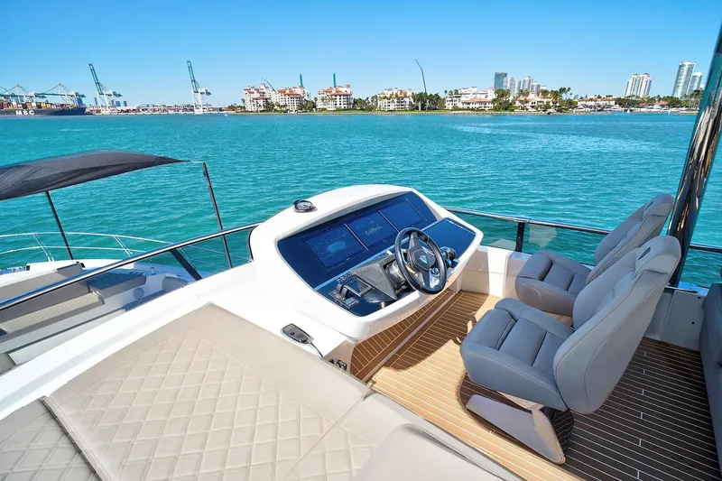 Slide: The Image of 2021 Fairline Squadron 68 yacht helm with luxurious seating and ocean view. - 16