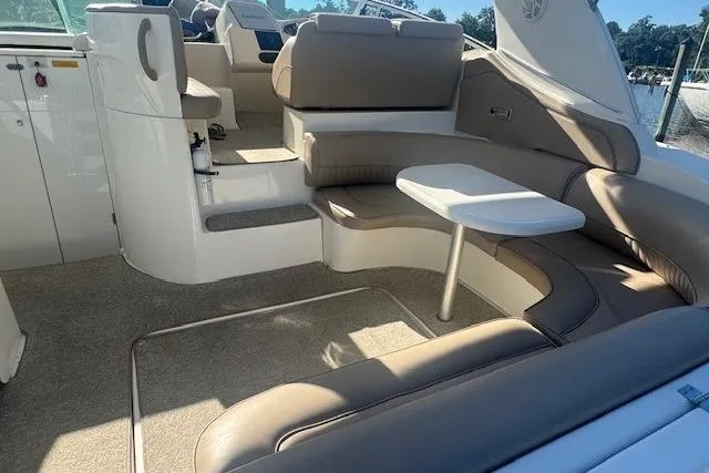 Slide: The Image of 2001 Cruisers Yachts 3672 Express interior with seating and table, showcasing luxury design. - 11