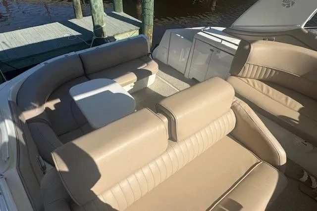 Slide: The Image of 2001 Cruisers Yachts 3672 Express interior with beige seating and table. - 13