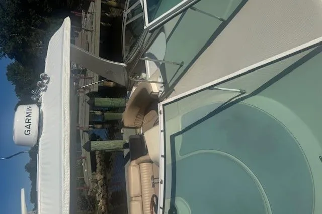 Slide: The Image of 2001 Cruisers Yachts 3672 Express docked, featuring Garmin equipment and spacious seating. - 16