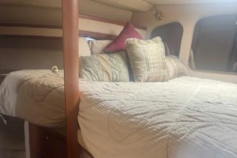 Slide: The Image of 2001 Cruisers Yachts 3672 Express cabin with cozy bed and decorative pillows. - 19