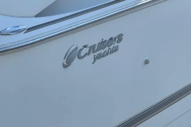 Slide: The Image of 2001 Cruisers Yachts 3672 Express logo on white yacht exterior. - 2