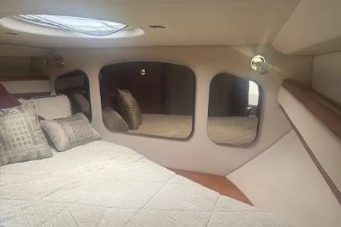 Slide: The Image of Interior of 2001 Cruisers Yachts 3672 Express with cozy bedding and elegant design. - 22