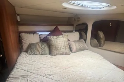 Slide: The Image of Luxurious cabin interior of 2001 Cruisers Yachts 3672 Express with plush bedding. - 24