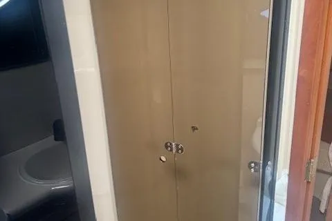 Slide: The Image of 2001 Cruisers Yachts 3672 Express bathroom with closed wooden cabinet doors. - 25