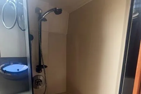 Slide: The Image of 2001 Cruisers Yachts 3672 Express bathroom with modern shower and mirror. - 26