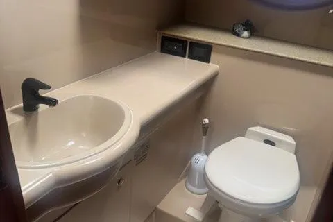 Slide: The Image of 2001 Cruisers Yachts 3672 Express bathroom with sink and toilet. - 27