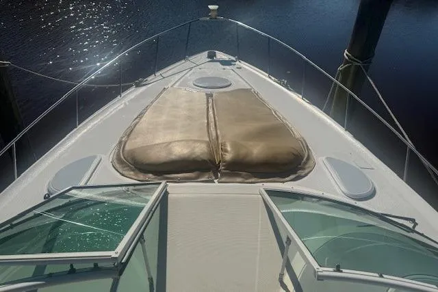 Slide: The Image of 2001 Cruisers Yachts 3672 Express boat deck with sun pads and water view. - 33