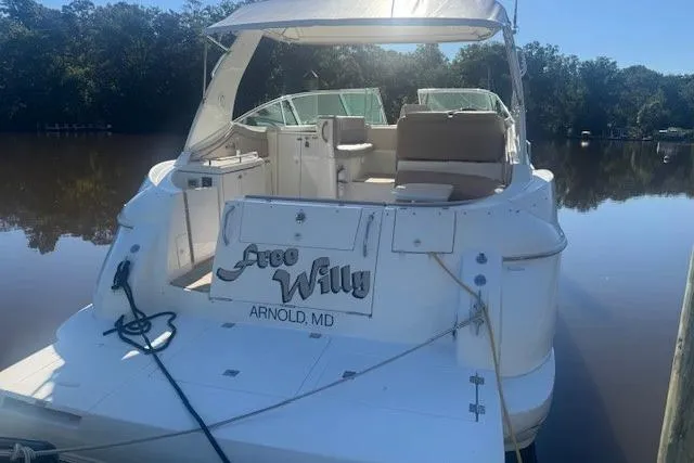 Slide: The Image of 2001 Cruisers Yachts 3672 Express docked on a calm river. - 5