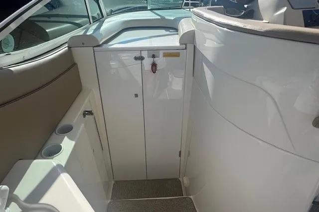 Slide: The Image of 2001 Cruisers Yachts 3672 Express interior with white cabinetry and seating area. - 7