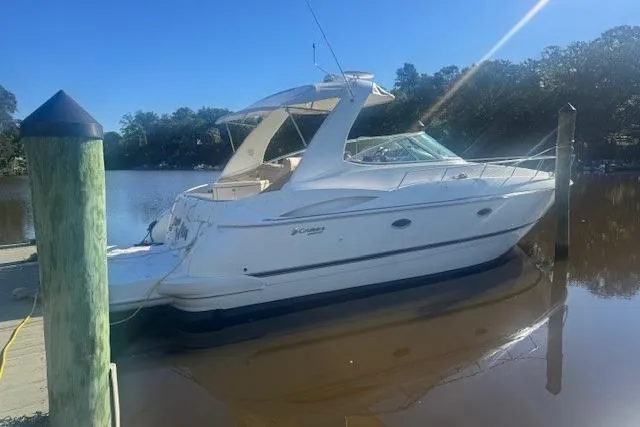 The Image of 2001 Cruisers Yachts 3672 Express docked on a sunny day by the water. - 0