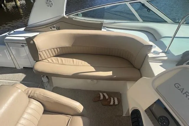 Slide: The Image of 2001 Cruisers Yachts 3672 Express interior with beige seating and dashboard view. - 12
