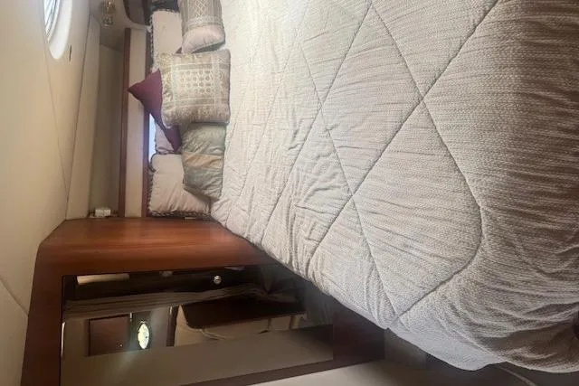 Slide: The Image of Interior cabin of 2001 Cruisers Yachts 3672 Express with bed and pillows. - 23