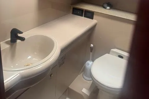 Slide: The Image of 2001 Cruisers Yachts 3672 Express bathroom with sink and toilet. - 28