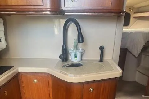 Slide: The Image of 2001 Cruisers Yachts 3672 Express kitchen with wooden cabinets and modern sink. - 29