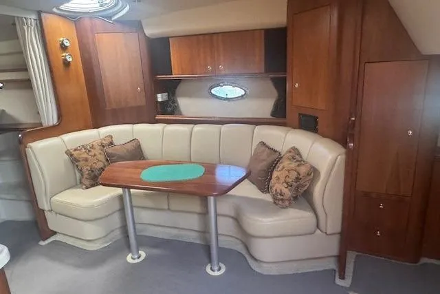 Slide: The Image of Interior of 2001 Cruisers Yachts 3672 Express with plush seating and wooden accents. - 30