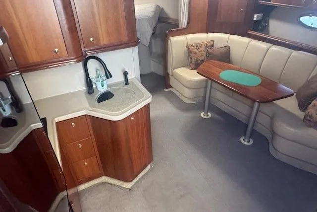 Slide: The Image of 2001 Cruisers Yachts 3672 Express interior with kitchenette and seating area. - 31