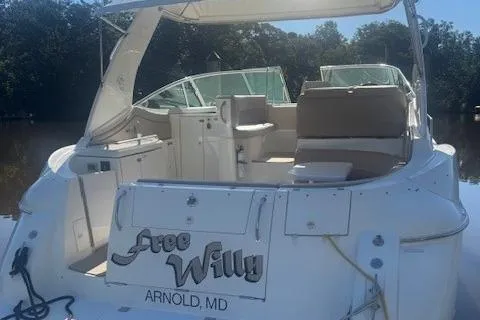 Slide: The Image of 2001 Cruisers Yachts 3672 Express boat docked, featuring spacious seating and canopy. - 4